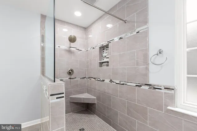 a view of a room with wooden floor and white walls