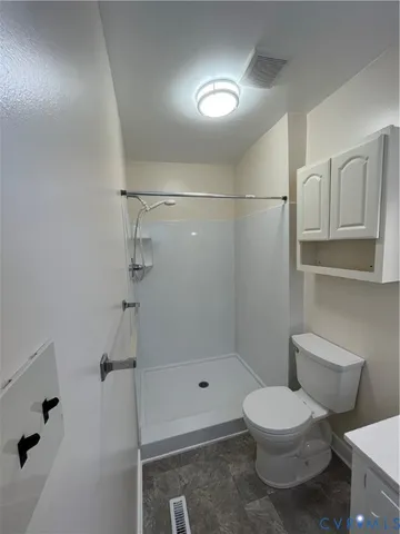 a bathroom with a toilet and shower