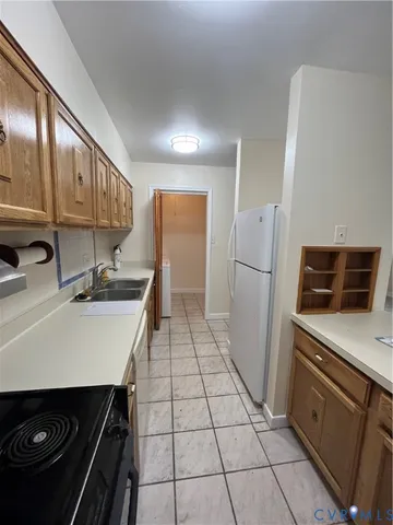a kitchen with a sink appliances and cabinets