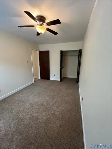 a view of an empty room with a ceiling fan