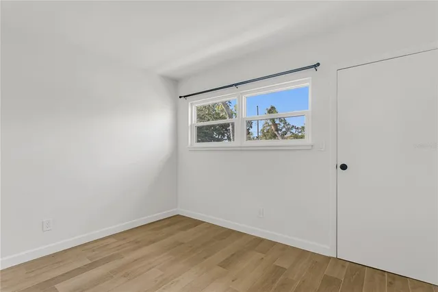 an empty room with a painting on the wall