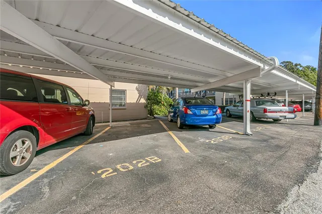 a view of parking garage with cars parked