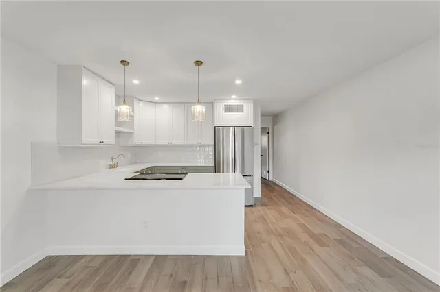 a view of a kitchen with a stove top oven