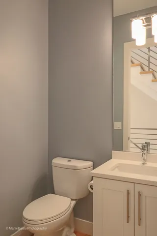 a white toilet sitting next to a bathroom sink