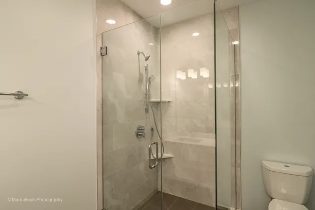 a bathroom with a shower and toilet