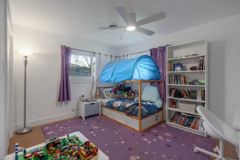 a bedroom with furniture and a book shelf