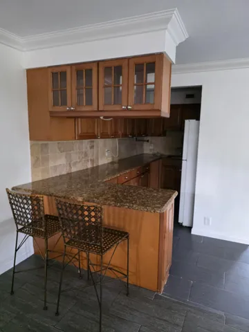 a kitchen with a table chairs and a refrigerator