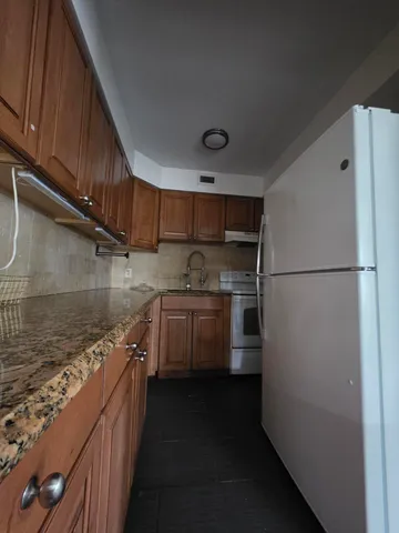 a kitchen with stainless steel appliances a refrigerator and a stove