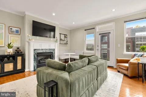 a living room with furniture fireplace and flat screen tv