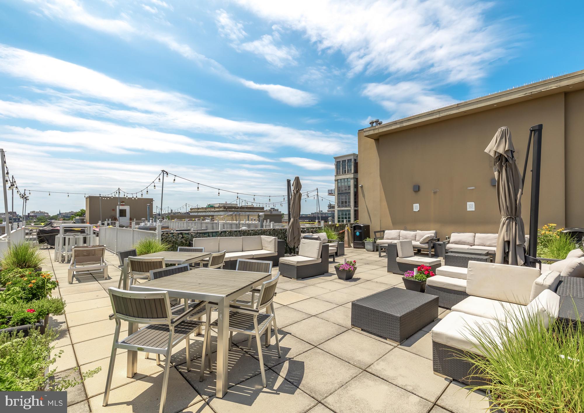 2004 11th Street Northwest, Unit 436 Washington, DC 20001 - Photo 15 of 15 a view of a patio with couches and chairs under an umbrella