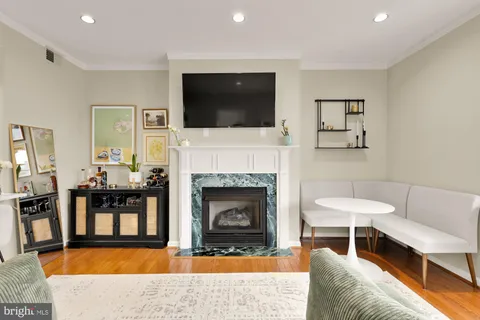 a living room with furniture a flat screen tv and a fireplace