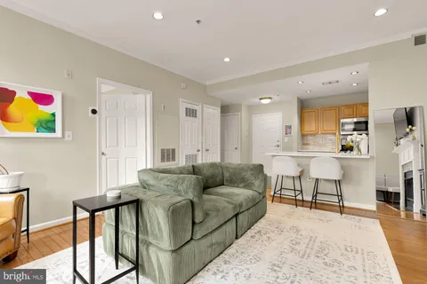 a living room with furniture and kitchen view