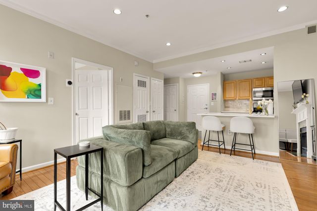 a living room with furniture and kitchen view