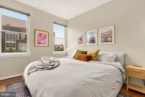 a bed sitting in a bedroom next to a window