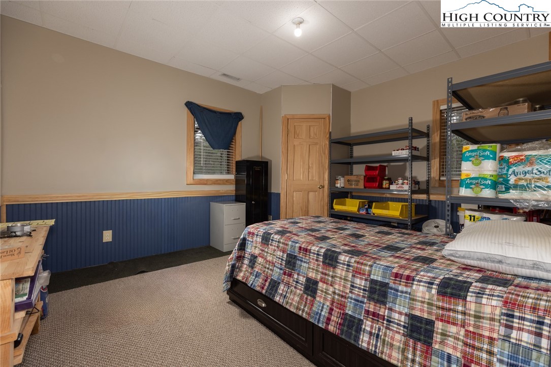 268 Roaring Ridge Road Deep Gap, NC 28618 - Photo 22 of 34 a bedroom with a bed a window and dresser