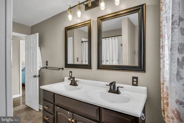 a kitchen with granite countertop stainless steel appliances a table and chairs in it