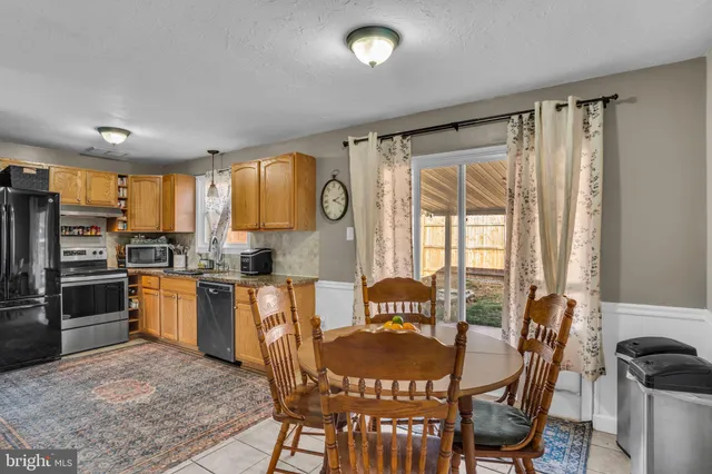 a kitchen with stainless steel appliances granite countertop a stove and a refrigerator