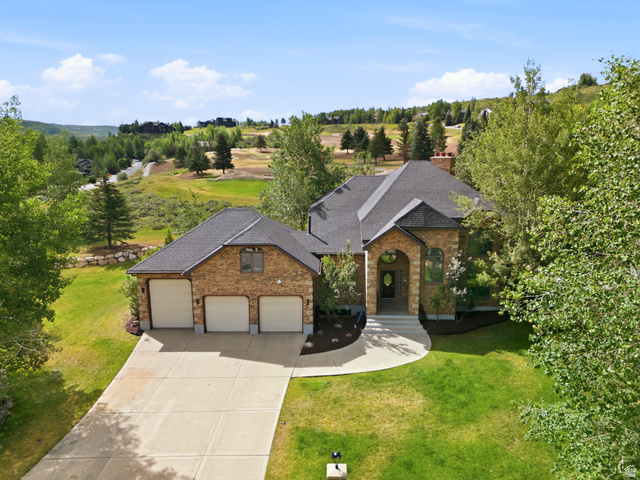 3535 Homestead Road Park City, UT 84098 - Photo 1 of 81 Stone and brick facade residence featuring a multi-car garage, dark shingle roof, arched entry, and a concrete driveway