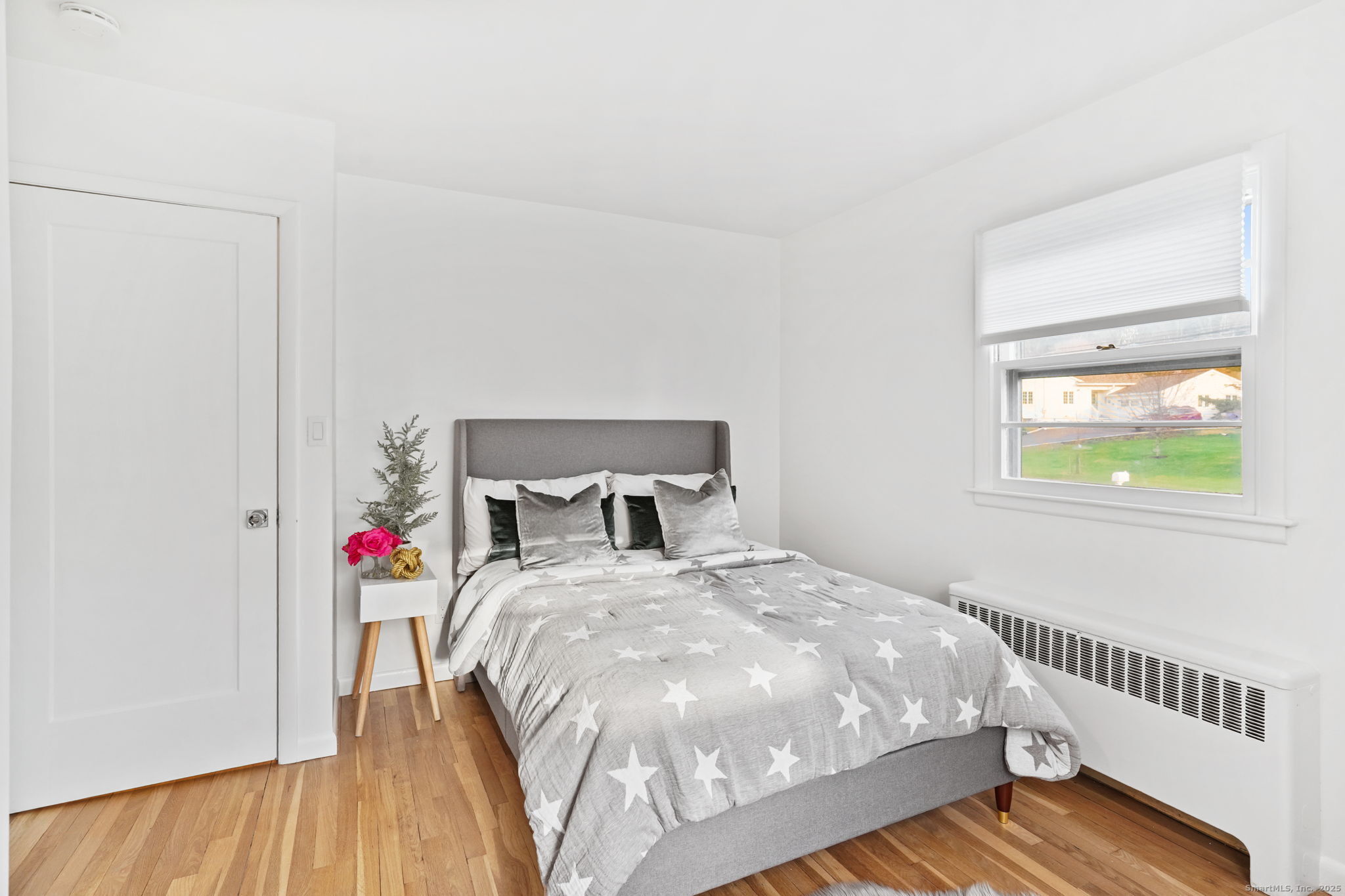 132 Toll House Lane Fairfield, CT 06825 - Photo 18 of 38 a bed sitting in a bedroom next to a window