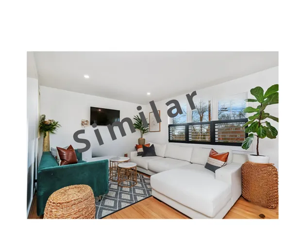 a living room with furniture and a lamp