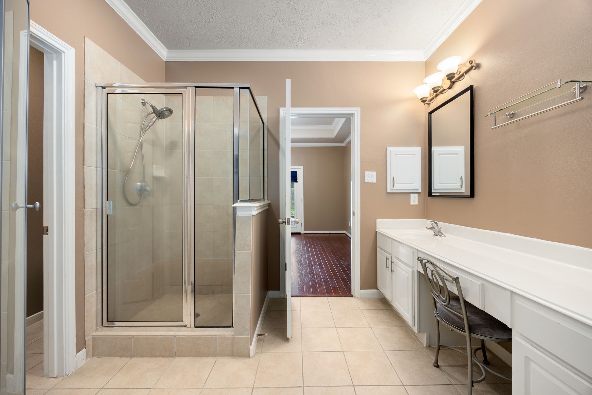 4526 Countrypines Drive Spring, TX 77388 - Photo 24 of 38 This additional view of the primary bathroom highlights a separate, glass-enclosed walk-in shower with tile surround.