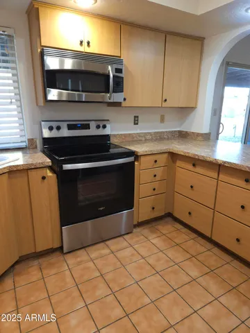 a kitchen with stainless steel appliances a stove sink and microwave