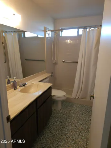 a bathroom with a double vanity sink toilet and shower