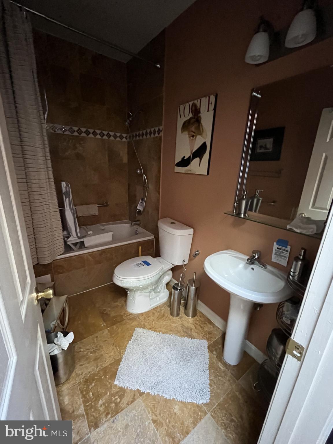 1109 Penn Street Northeast, Unit 4 Washington, DC 20002 - Photo 5 of 5 a bathroom with a sink mirror toilet and shower
