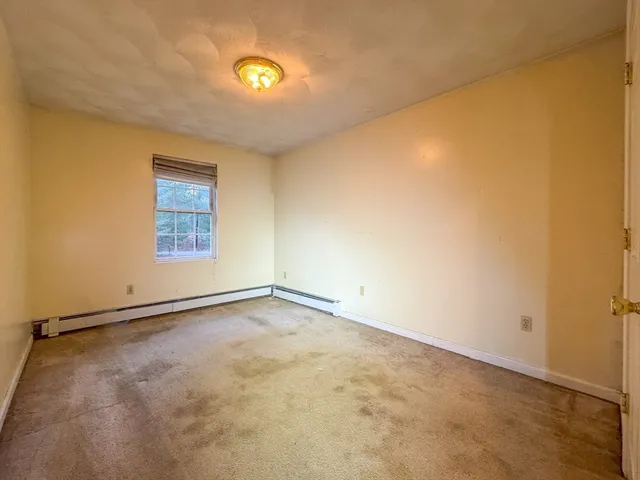 an empty room with a empty space and a window