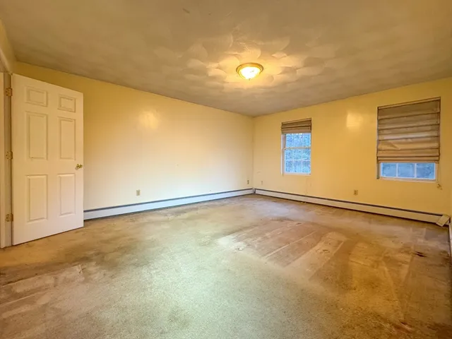 an empty room with a empty space and a window