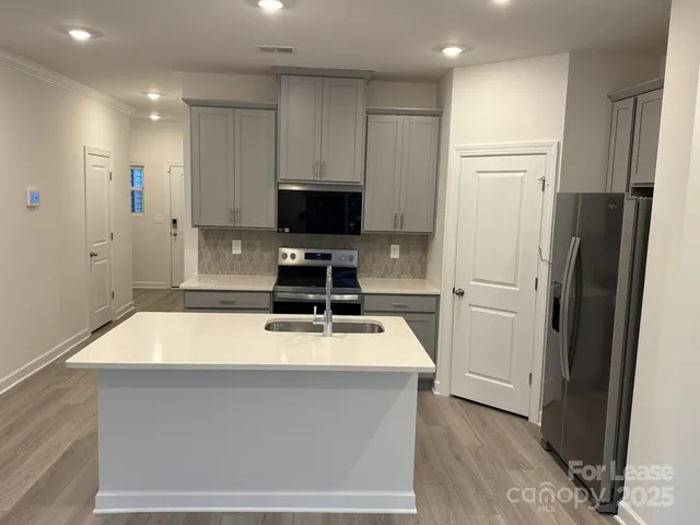 a kitchen with a refrigerator and a sink