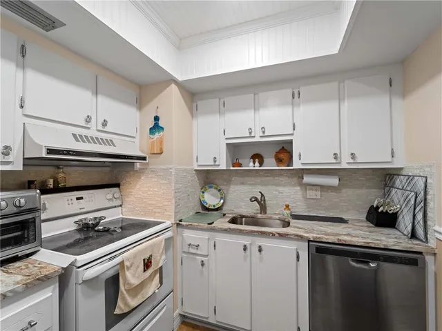 a bedroom with a bed mirror and a window