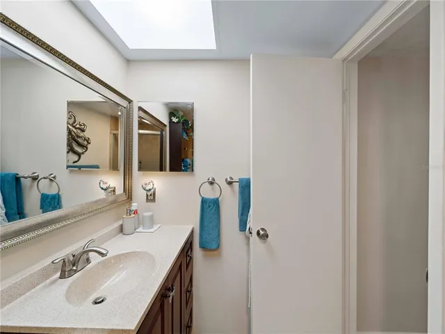 a view of a bedroom with a hanging floor to ceiling window and potted plant