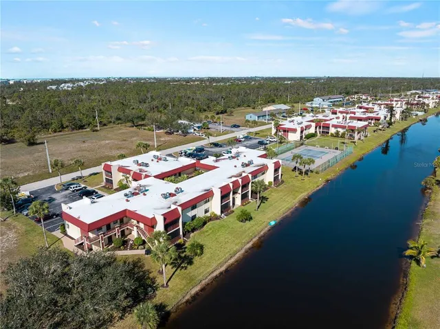 an aerial view of a house with a yard swimming pool and outdoor seating