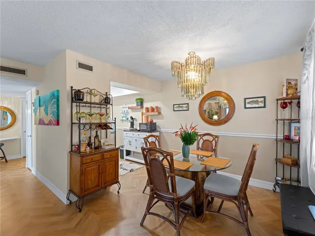 a living room with furniture a bookshelf and a window