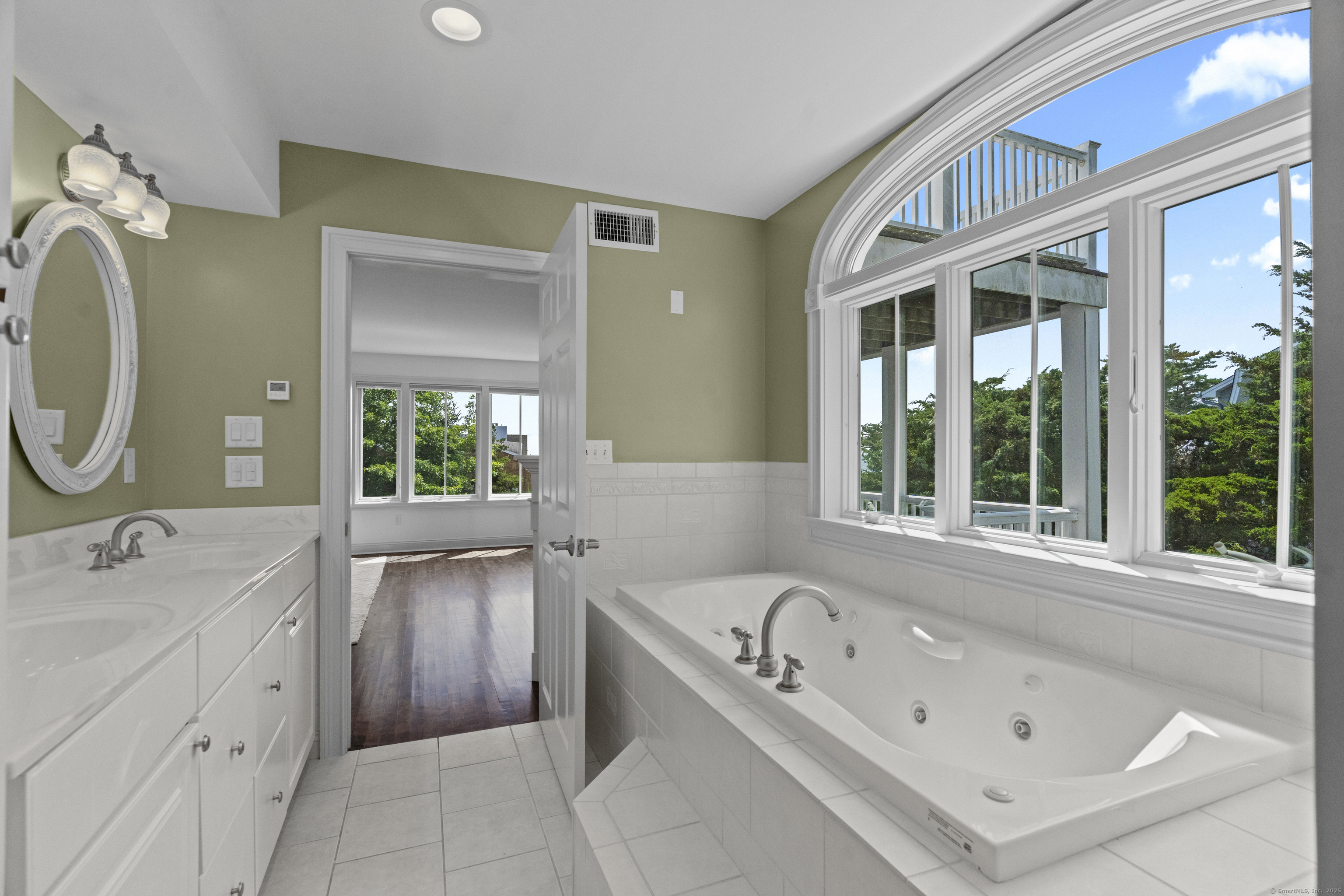 64 Webster Point Road Madison, CT 06443 - Photo 23 of 36 a bathroom with a tub sink and mirror