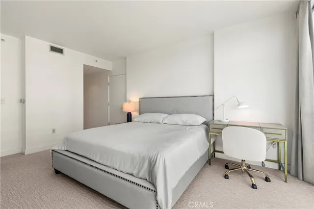 a bedroom with a bed and with a mirror