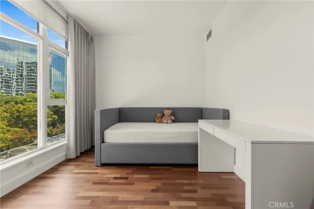 a spacious bedroom with a bed and a large window