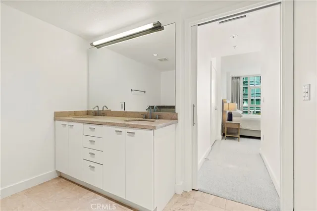 a en suite bathroom with a sink and a mirror