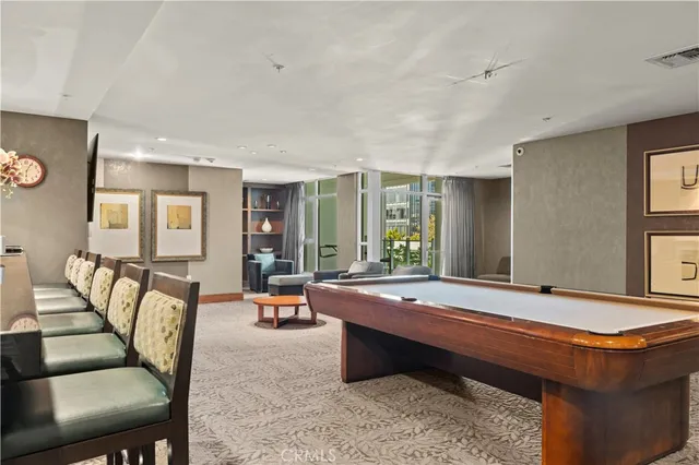 a room with furniture pool table and flat screen tv