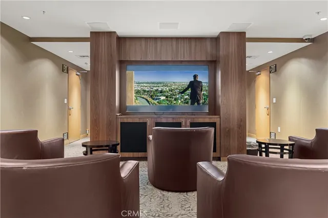 a living room with furniture a window and a flat screen tv