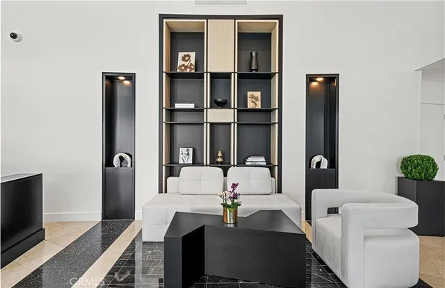 a living room with furniture wooden floor and a large window