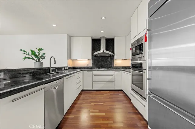 a kitchen with granite countertop stainless steel appliances and counter space