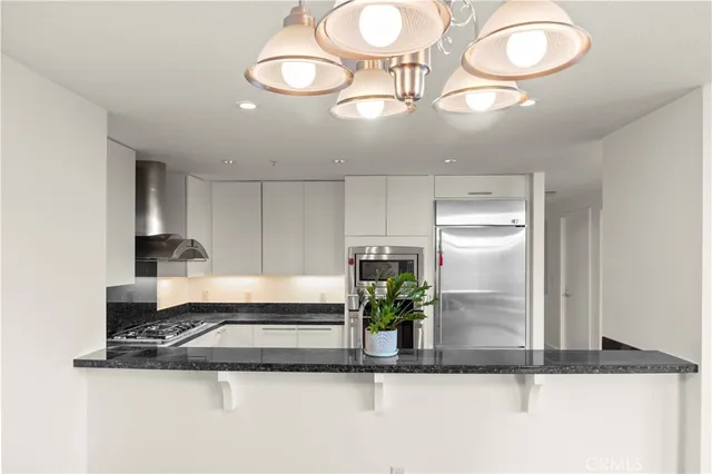 a view of a kitchen with a sink and a stove top oven