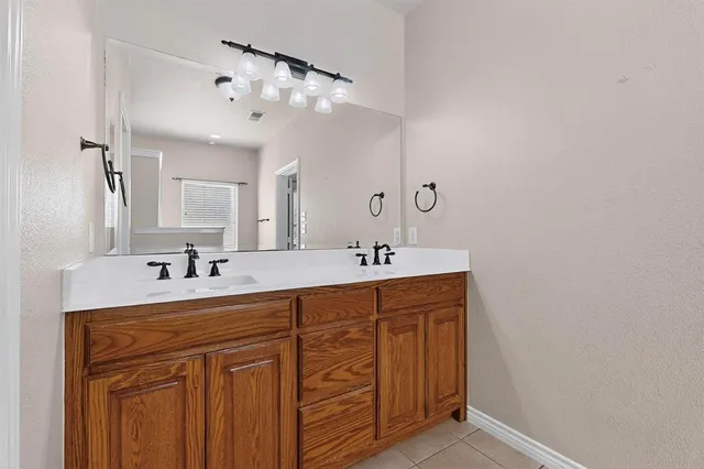 a bathroom with a sink vanity and mirror