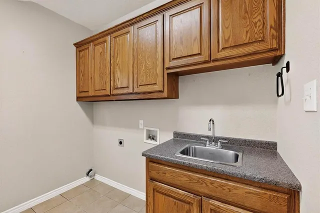 a kitchen with a sink cabinets and utility