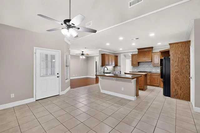 a large kitchen with a large counter top and stainless steel appliances