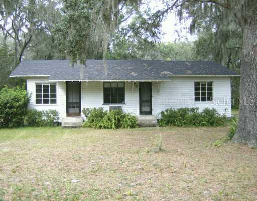 4395 Wolf Road DeLand, FL 32724 - Photo 1 of 1 a front view of a house with a garden