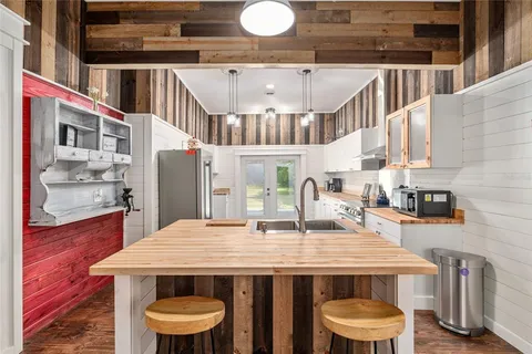 a bathroom with a granite countertop toilet a sink and shower