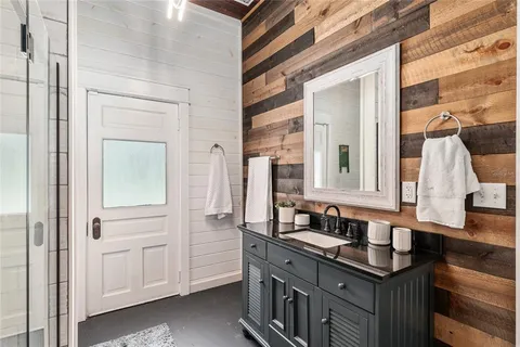 a bathroom with a sink toilet and shower